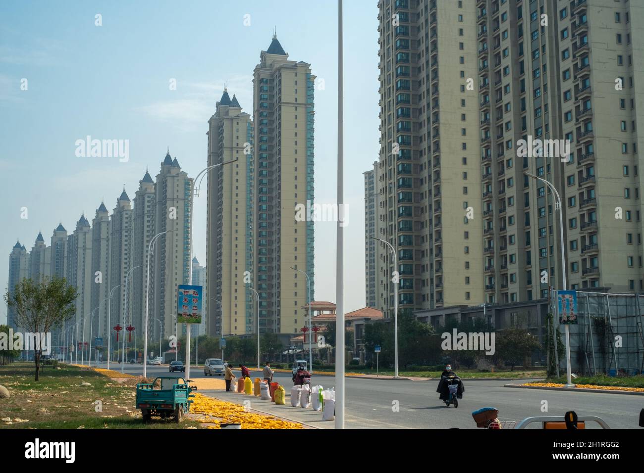 Lokale Dorfbewohner trocknen Mais vor den Evergrande Wohnimmobilien im Bezirk Wuqing, Tianjin, China. 19-Okt-2021 Stockfoto