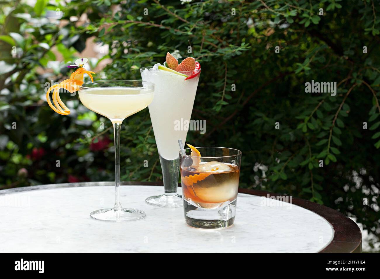 Set mit drei Cocktails auf einem Tisch im Garten Stockfoto