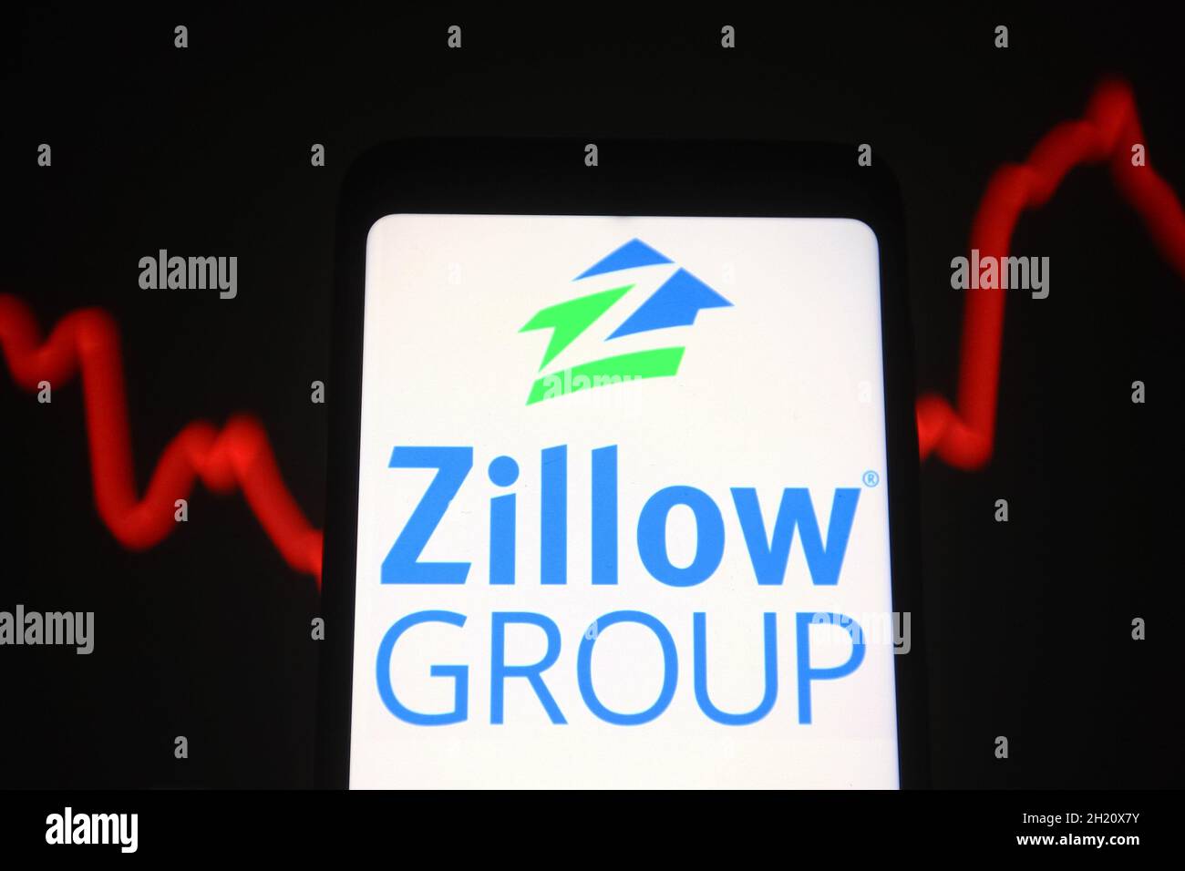 Ukraine. Oktober 2021. In dieser Fotobilder wird das Logo der Zillow Group Inc. Auf einem Smartphone-Bildschirm und eine rote Linie einer Grafik im Hintergrund angezeigt. (Bild: © Pavlo Gonchar/SOPA Images via ZUMA Press Wire) Stockfoto