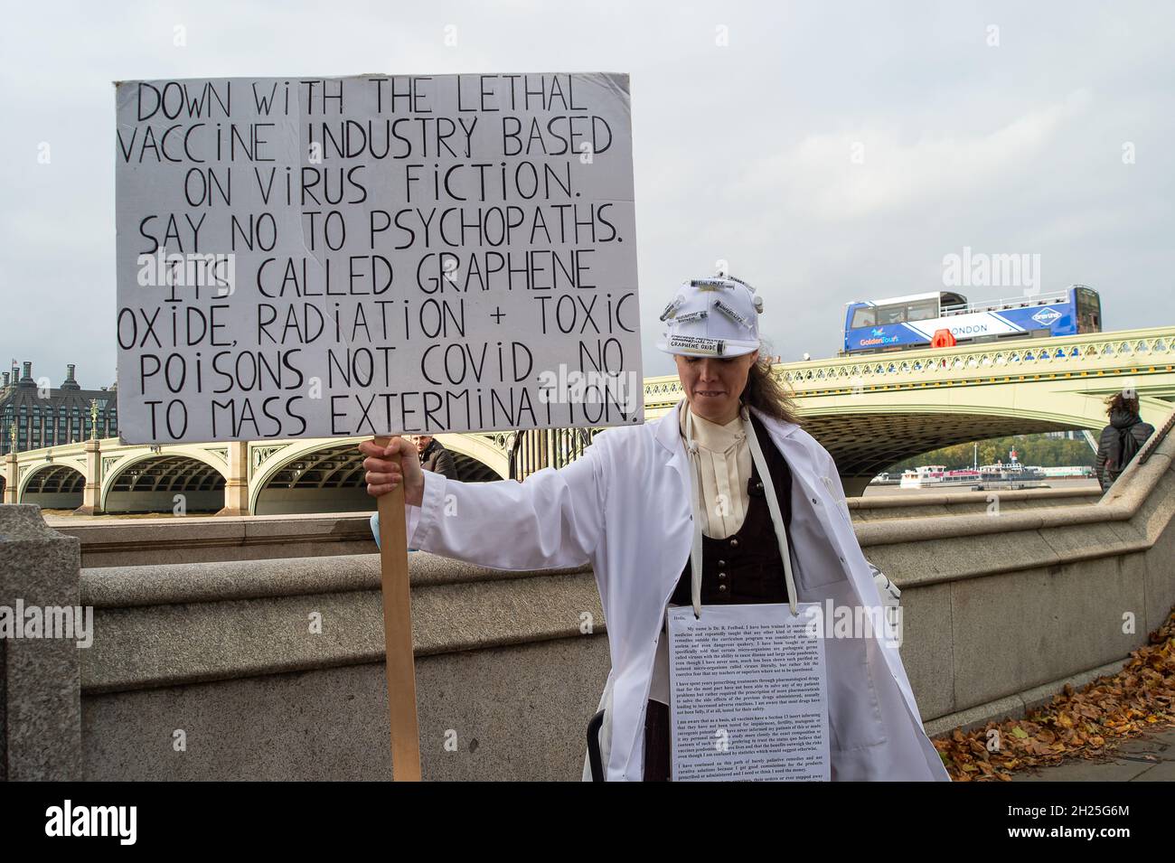 London, Großbritannien. Oktober 2021. Ein Anti-Vaxxxer-Protester trägt Spritzen auf einem Hut und hält ein Plakat vor dem St. Thomas' Hospital in London hoch. Quelle: Maureen McLean/Alamy Stockfoto