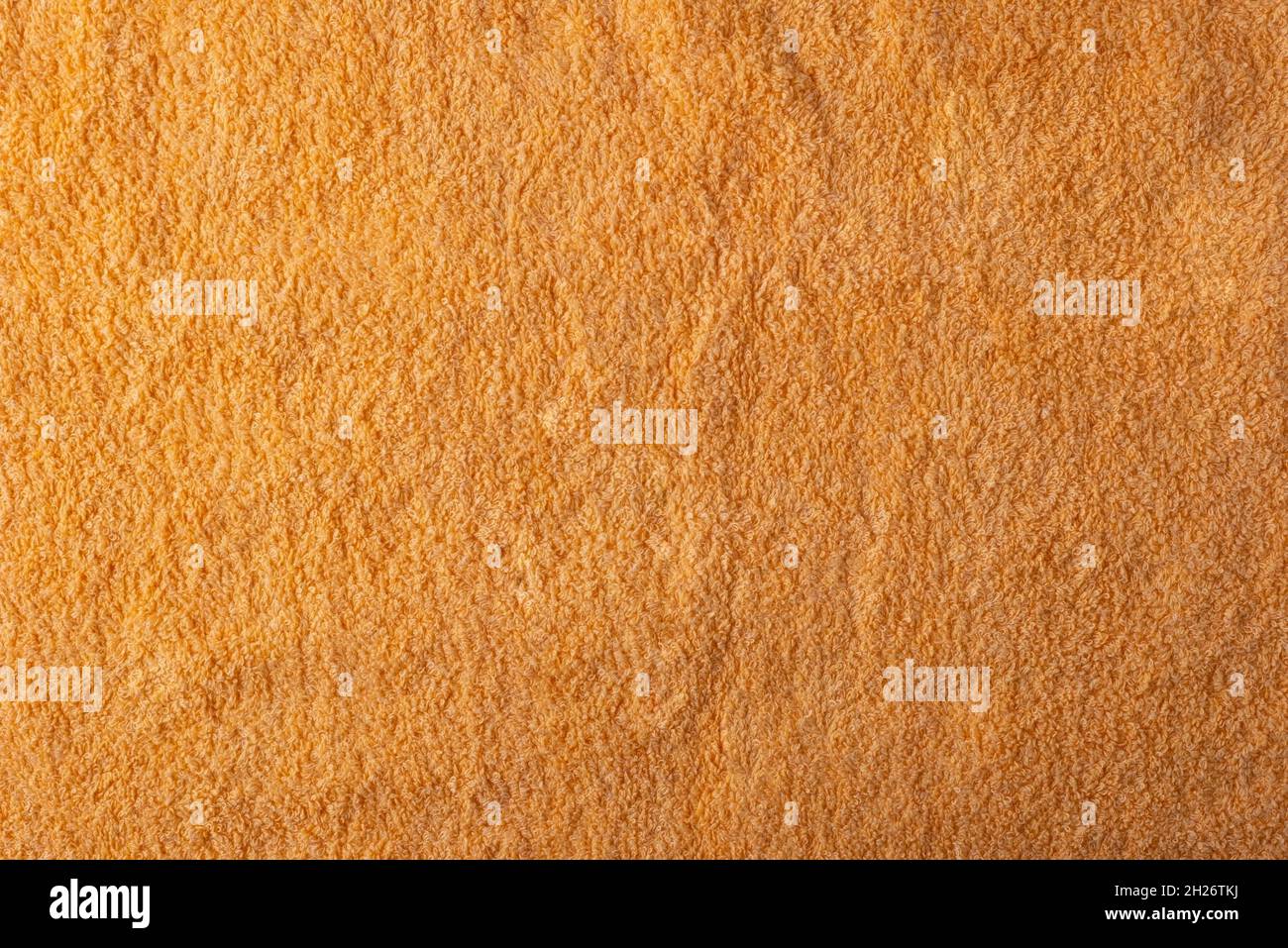 Textur aus orangefarbenem Handtuch, Nahaufnahme, Draufsicht. Stockfoto