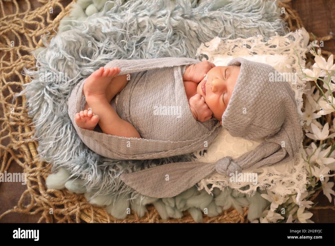 6 Monate alte kleine süße arabische muslimische Mädchen legen und posieren auf bequeme Wolle niedliches Gesicht Draufsicht Portrait grau weichen Schal Stockfoto