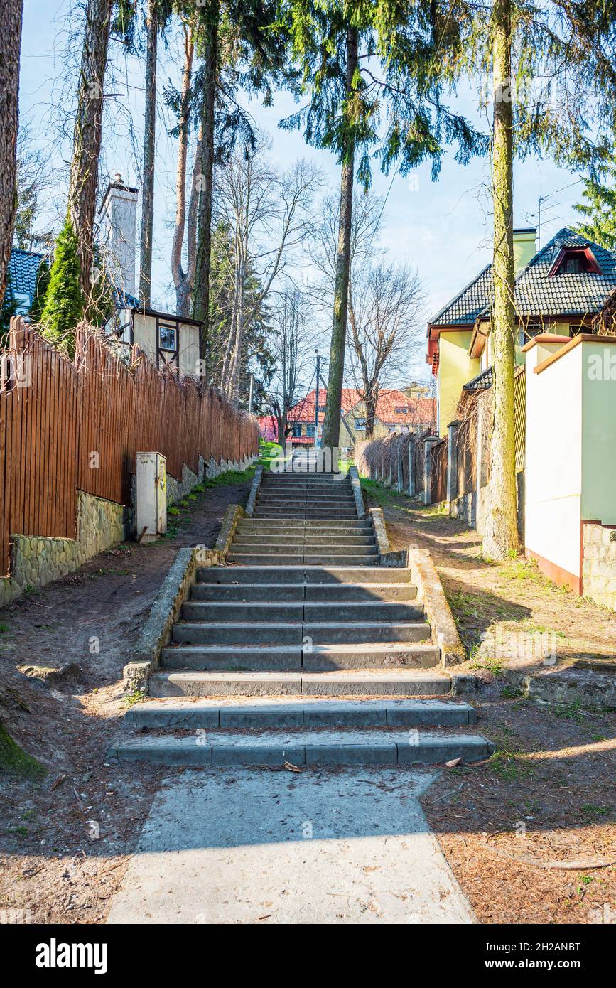 Eine Steintreppe in der Stadt zwischen gemütlichen Hütten und Pinien Stockfoto