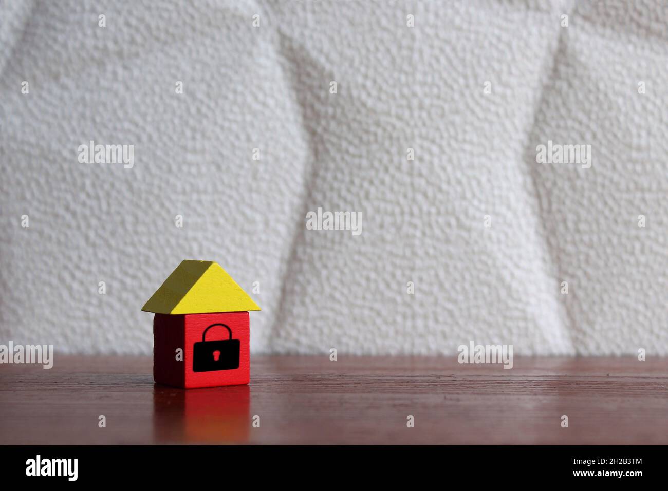 Sicherheits-, Sicherheits- und Hausversicherungskonzept. Holzhaus mit Vorhängeschloss-Symbol auf dem Tisch. Platz für Text kopieren. Stockfoto Sicherheits-, Sicherheits- und Hausversicherungskonzept. Holzhaus mit Vorhängeschloss-Symbol auf dem Tisch. Platz für Text kopieren. Stockfoto