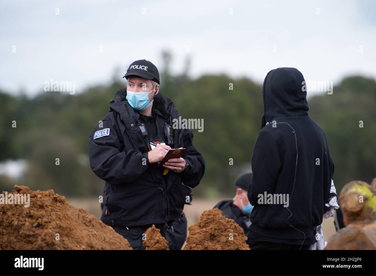 Chalfont St Peter, Großbritannien. Oktober 2021. Stopp HS2-Demonstranten aus dem Kriegslager Wendover aktiver Widerstand besetzten einen Bagger, der heute vor dem Gelände des HS2 Chalfont St Peter Hochwasserschutzarbeiten durchführte, wo die Überschwemmungen auf der Straße angeblich viel schlimmer wurden, seitdem HS2 vor Ort Bäume und Felder geräumt hat. Die Demonstranten gingen freiwillig, als das reguläre Thames Valley Police Team, das HS2 arbeitet, eintraf. Quelle: Maureen McLean/Alamy Live News Stockfoto