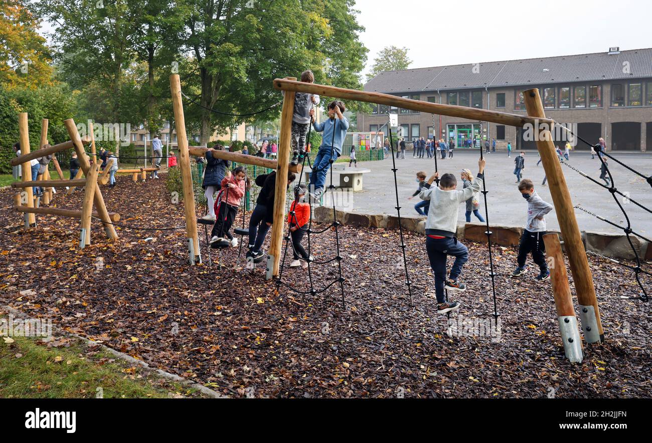 Mülheim an der Ruhr, Nordrhein-Westfalen, Deutschland - Schulhof unversiegelt, spielen Kinder auf dem neu gestalteten Schulhof am Klettergerüst Stockfoto