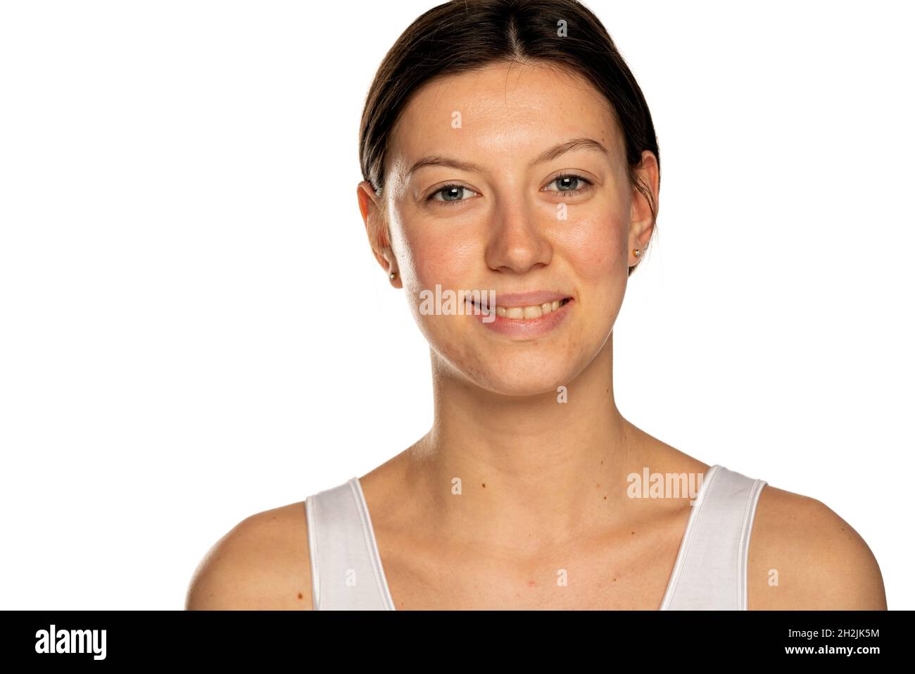 Schöne junge lächelnde Frau ohne Make-up auf weißem Hintergrund Stockfoto