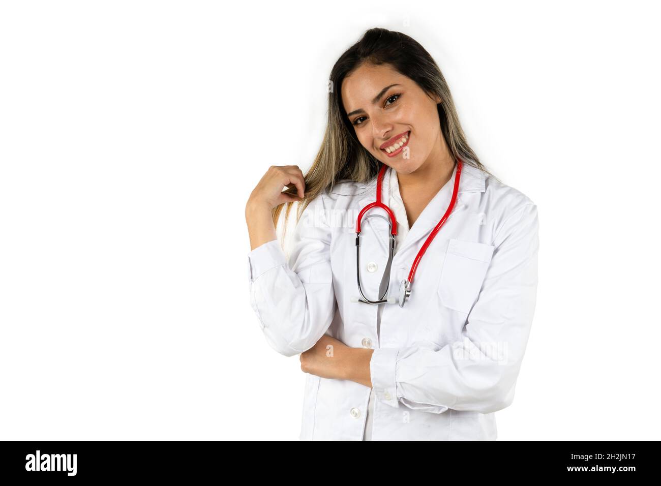 Junger Arzt mit einem großen Lächeln auf weißem Hintergrund. Konzept der professionellen Frau, Gesundheitspersonal. Stockfoto