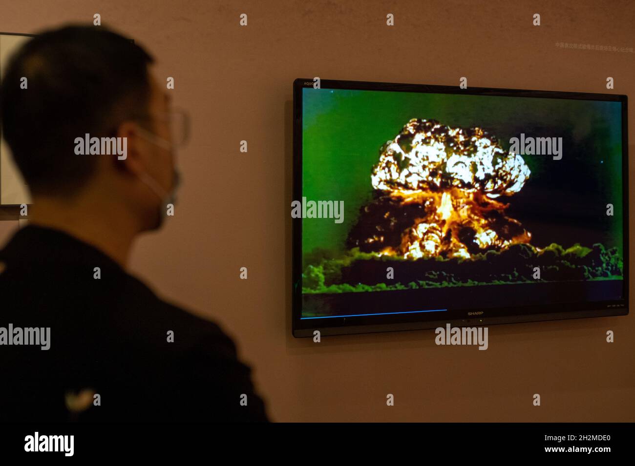 Chinesischer Besucher, der sich das Video der ersten Atombombenexplosion am 16. Oktober 1964 im Nationalmuseum von China ansieht. 23-Okt-2021 Stockfoto
