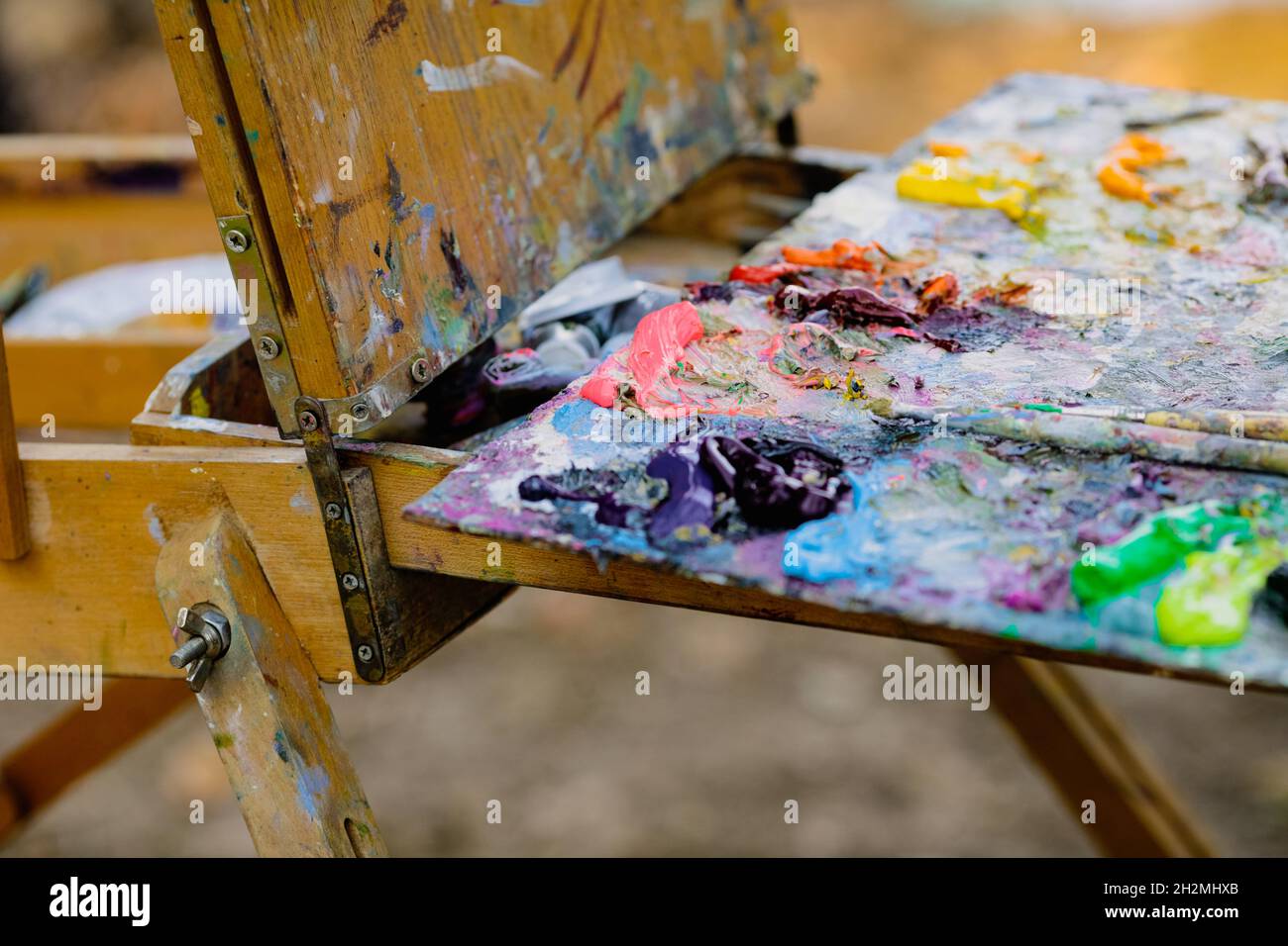Bild mit geringer Schärfentiefe (selektiver Fokus) und einer Farbpalette für Maler, während an einem sonnigen Herbsttag eine Landschaft gemalt wird. Stockfoto