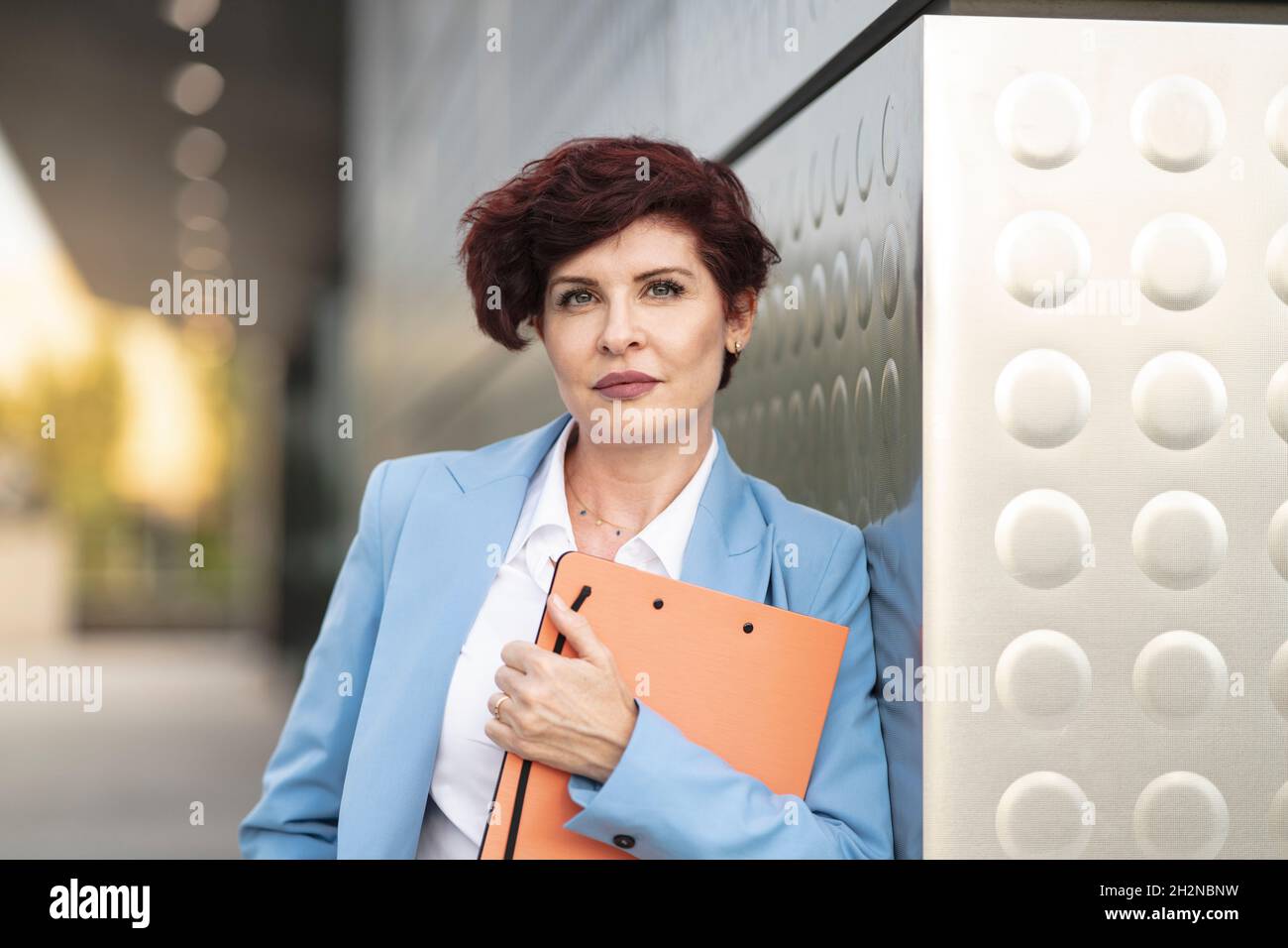 Reife Geschäftsfrau mit kurzen Haaren halten Datei Stockfoto