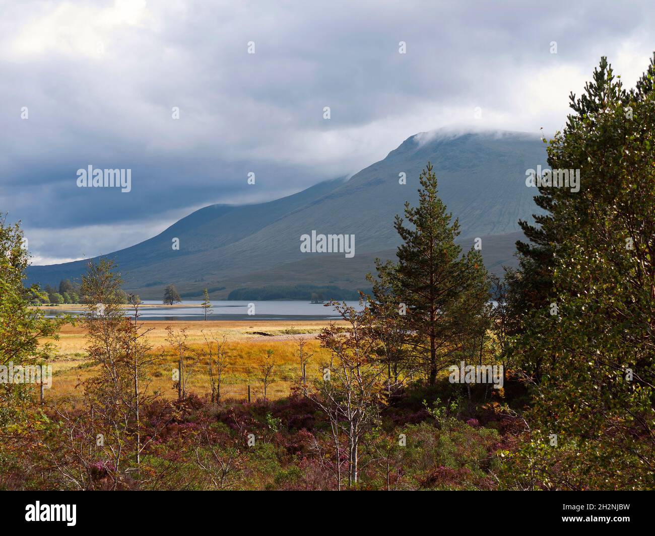 Loch Tulla, in der Nähe von Rannoch Moor, Schottische Highlands. Vom West Highland Way an der Victoria Bridge aus gesehen, bildet die Bridge of Orchy Hills den Hintergrund. Stockfoto