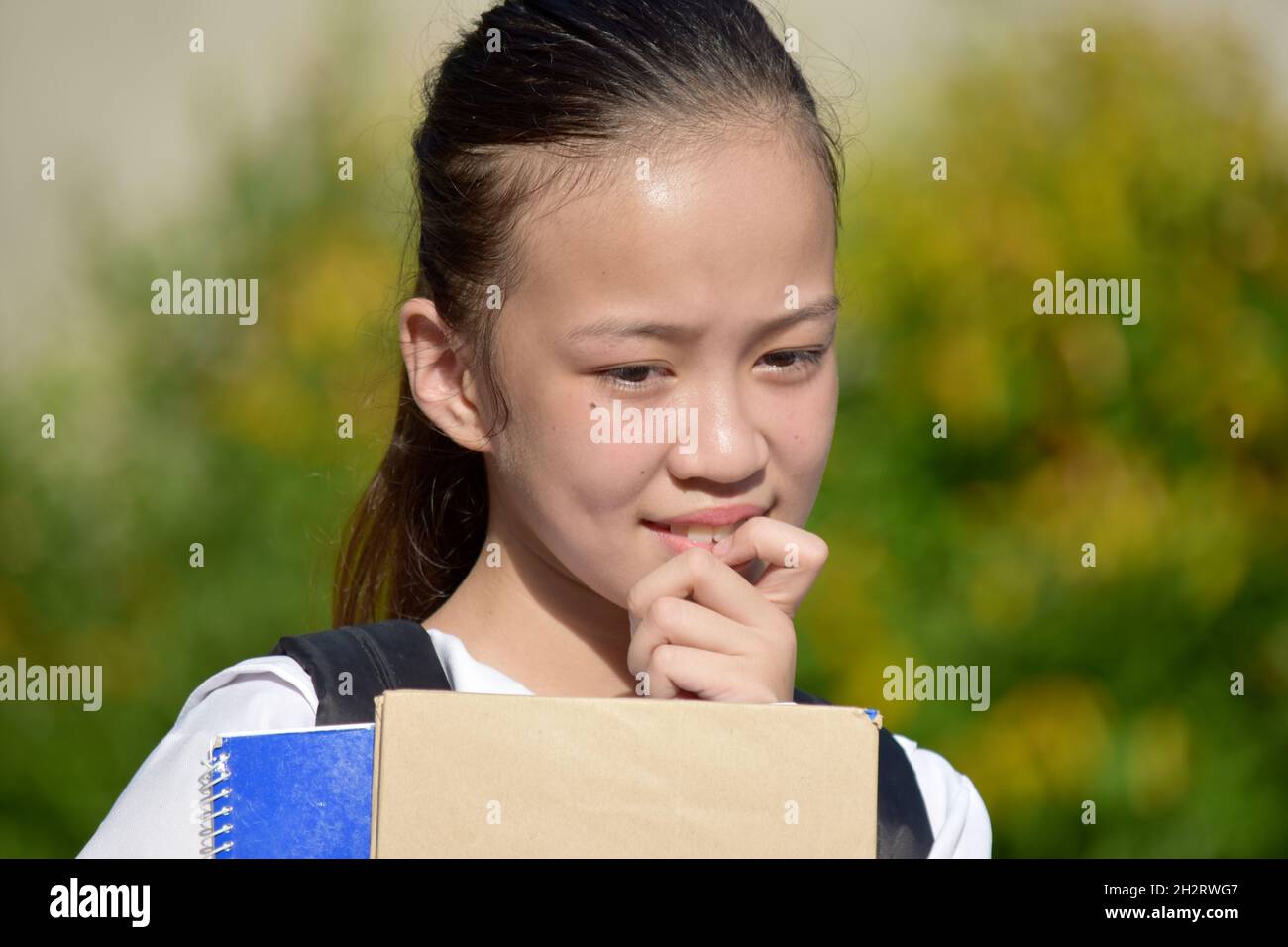 Thinking Asian School Girl Mit Büchern Stockfoto