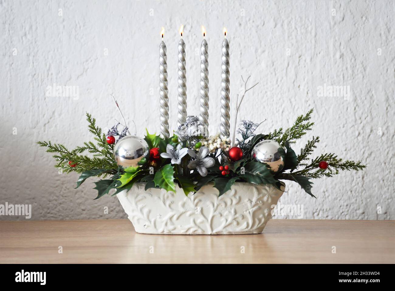 Weihnachtsdekoration mit vier brennenden Adventskerzen Stockfoto