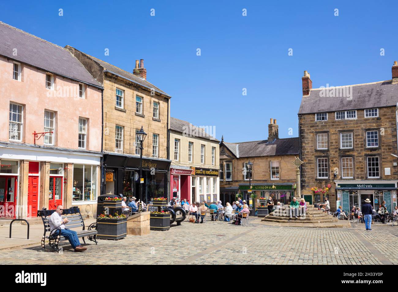 Die Menschen auf dem historischen Marktplatz und dem Markt überqueren das Stadtzentrum von Alnwick Alnwick Northumberland Northumbria England GB Europa Stockfoto