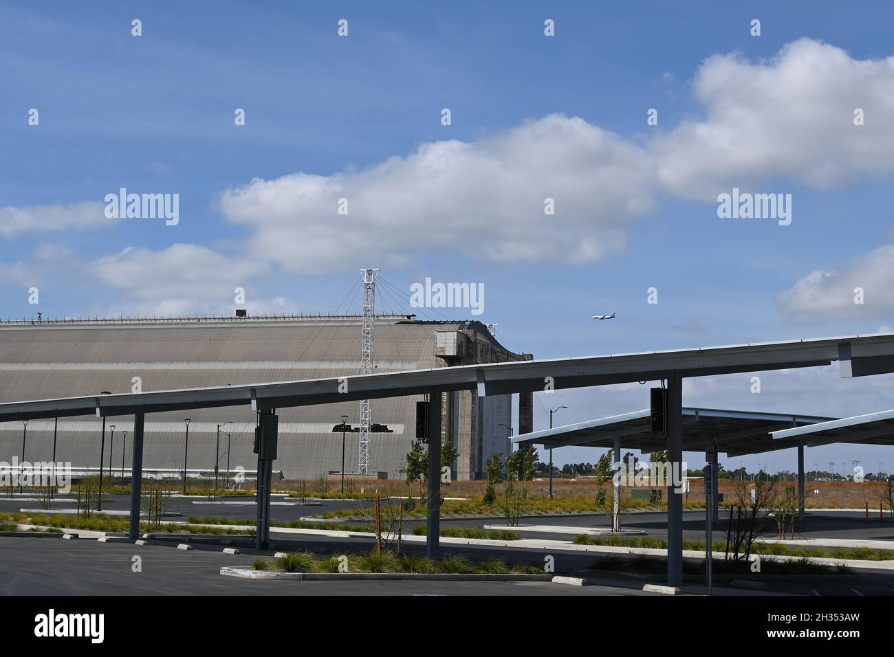 TUSTIN, KALIFORNIEN - 24 Okt 2021: Sonnenkollektoren auf dem Parkplatz der Legacy Magnet Academy mit dem Blimp Hanger im Hintergrund. Stockfoto