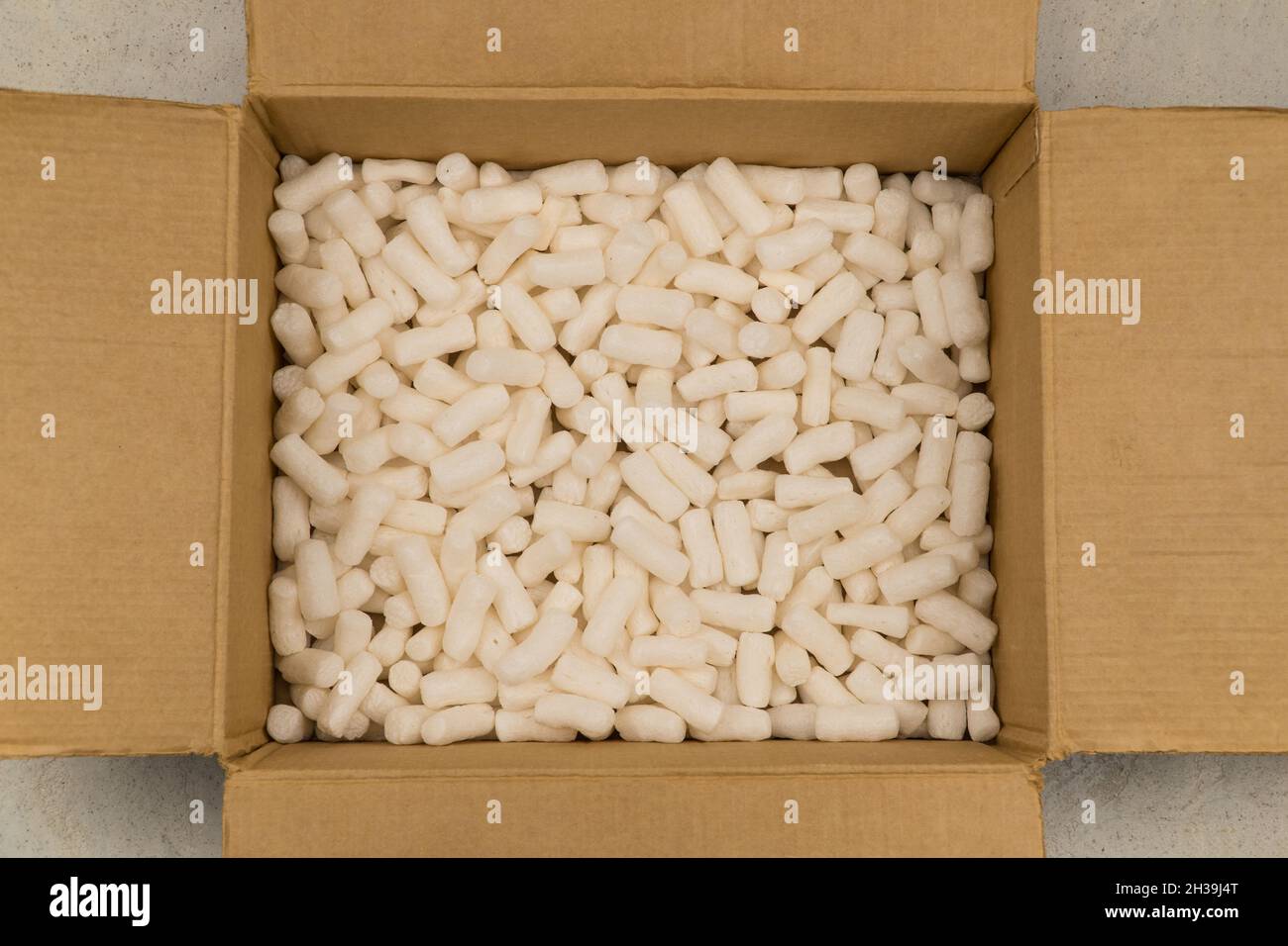 Leerer Karton mit Styroporfüller für sicheres Verpacken. Draufsicht Stockfoto
