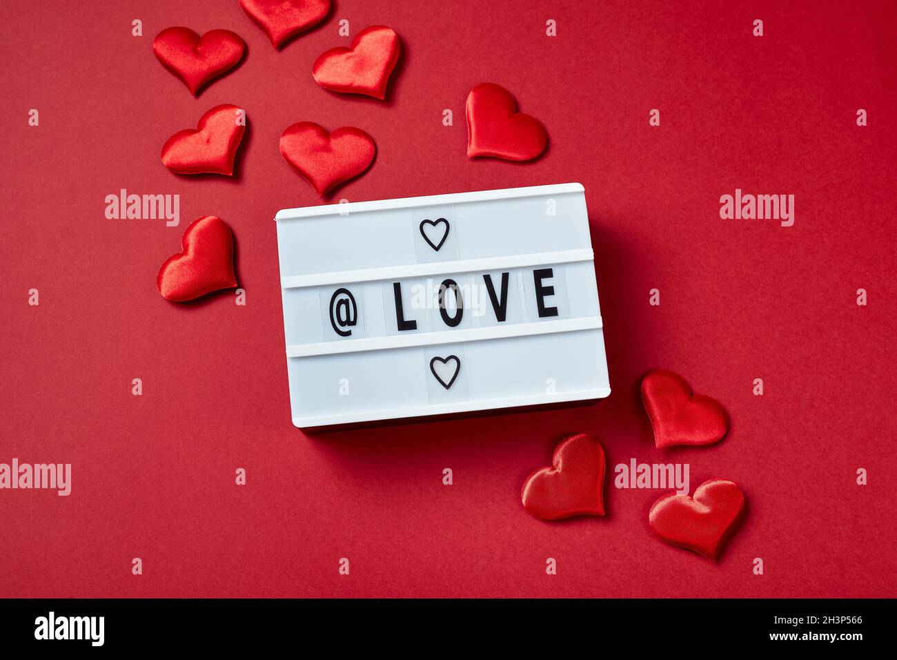 Liebe Leuchtkasten Nachricht mit roten Herzen auf rotem Hintergrund Stockfoto