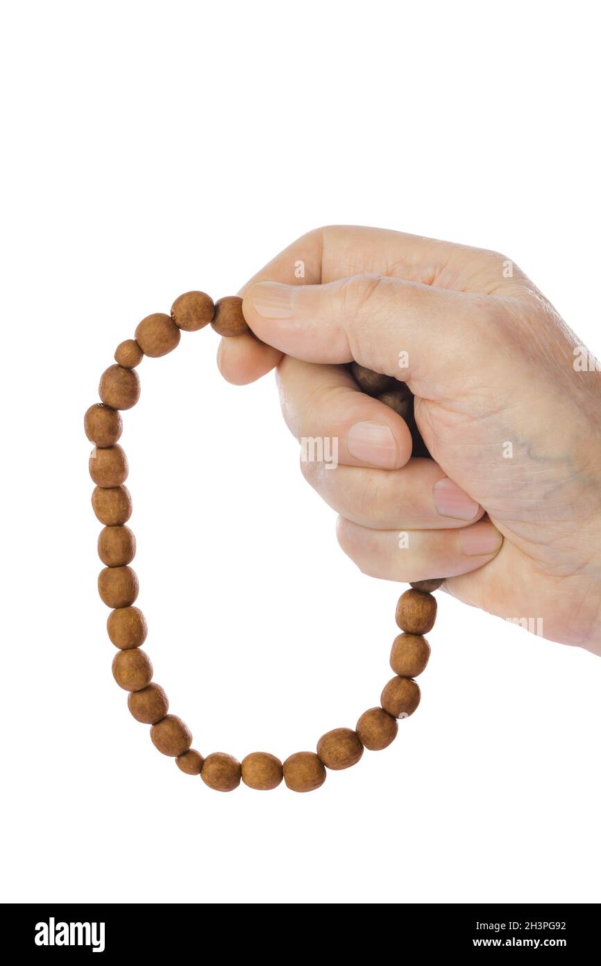 Hand mit gebetsperlen Stockfoto