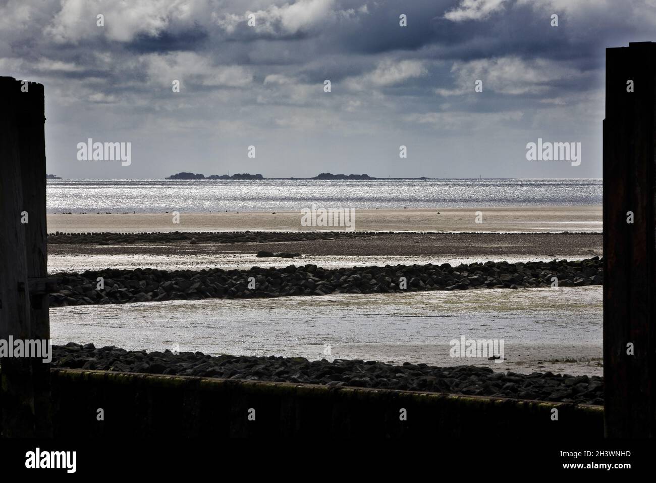 Blick vom Pier in Amrum auf die Nordsee mit dramatischer Atmosphäre und die Hallig Langeness Stockfoto