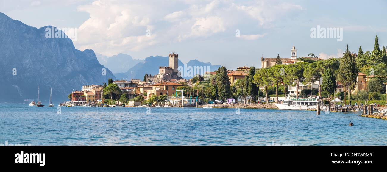 Idyllische Küste in Italien: Blaues Wasser und ein süßes Dorf am gardasee, Malcesine Stockfoto
