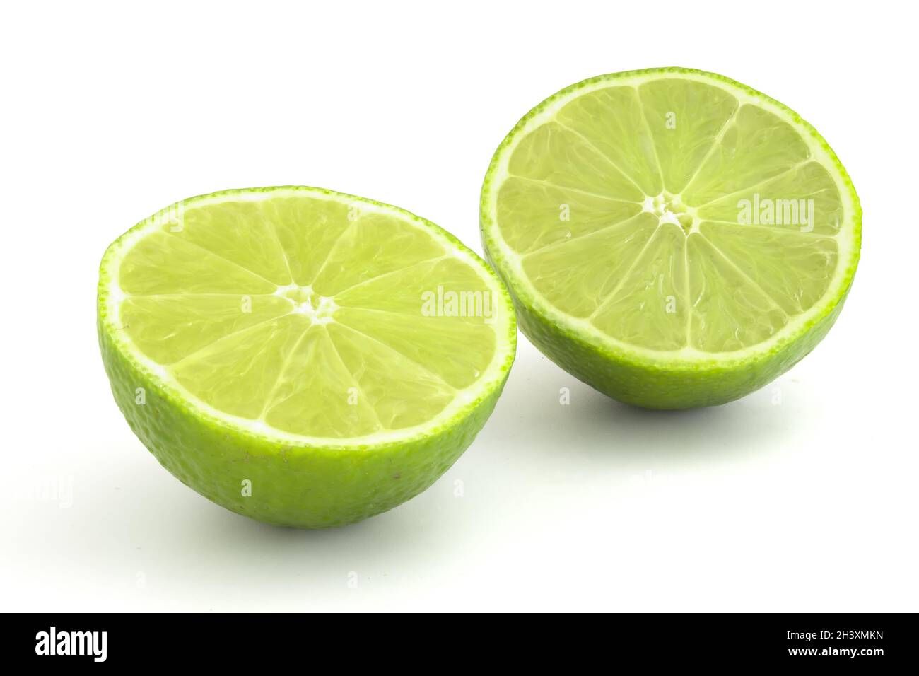 Kalk im Abschnitt isoliert auf weißem Hintergrund. Reife grüne Zitrusfrüchte für Cocktails und alkoholische Getränke. Stockfoto