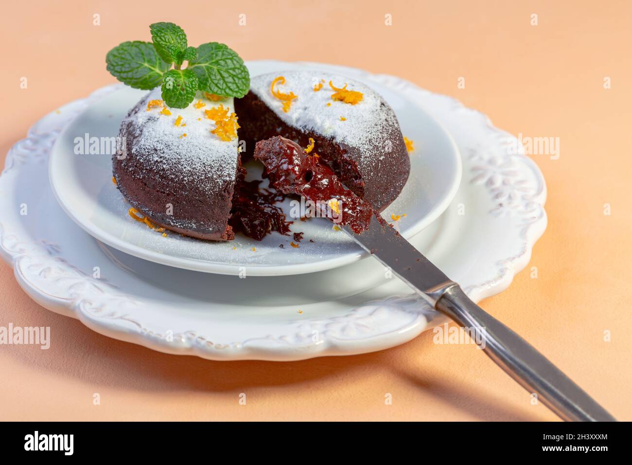 Schokoladenkuchen mit Kakaopulver und Orangenschale. Stockfoto