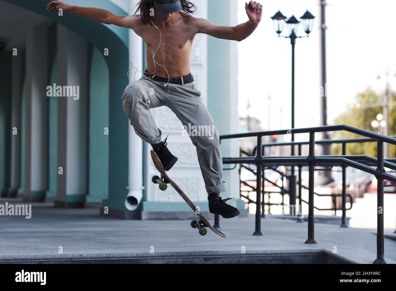 Junge Reiten Trick auf Skateboard in der Stadt Stockfoto