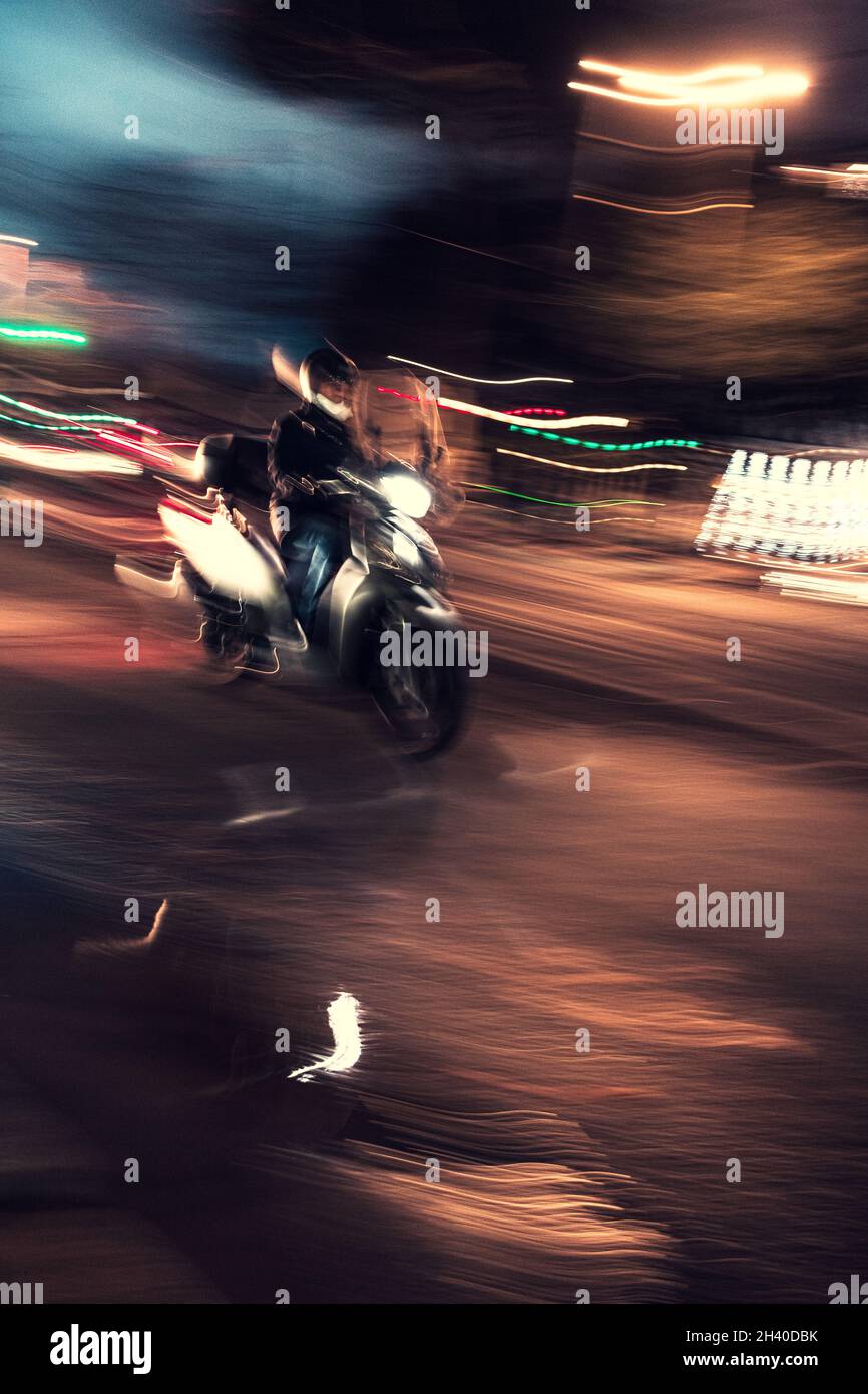 Verkehr in der Nacht. Langzeitaufnahme von Autos, die in der Stadt Rom vorbeifahren Stockfoto