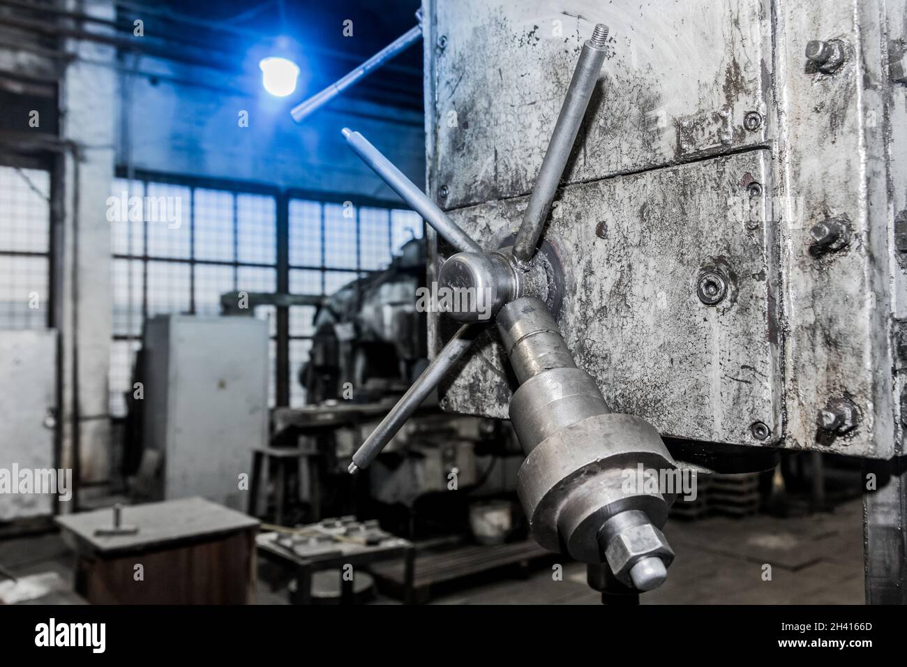 Eisengriff-Werkzeug und Teil der alten Ausrüstung der Fräsmaschine für die Metallbearbeitung in der Werkstatt des Industriewerks. Stockfoto