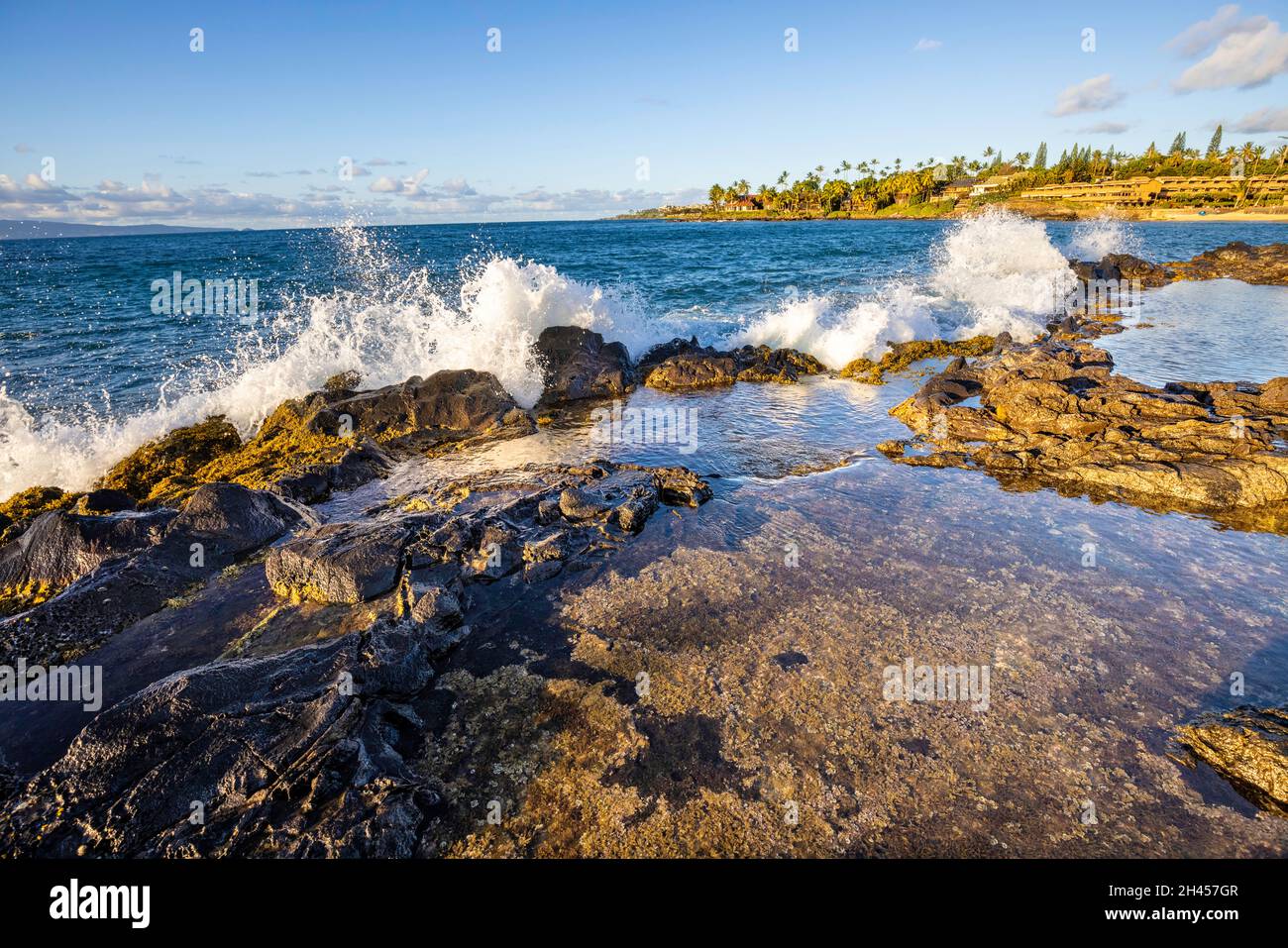 Wellen schlagen gegen die felsige Küste und in einen Tidepool am Kaopala Point, West Maui, Hawaii. Stockfoto