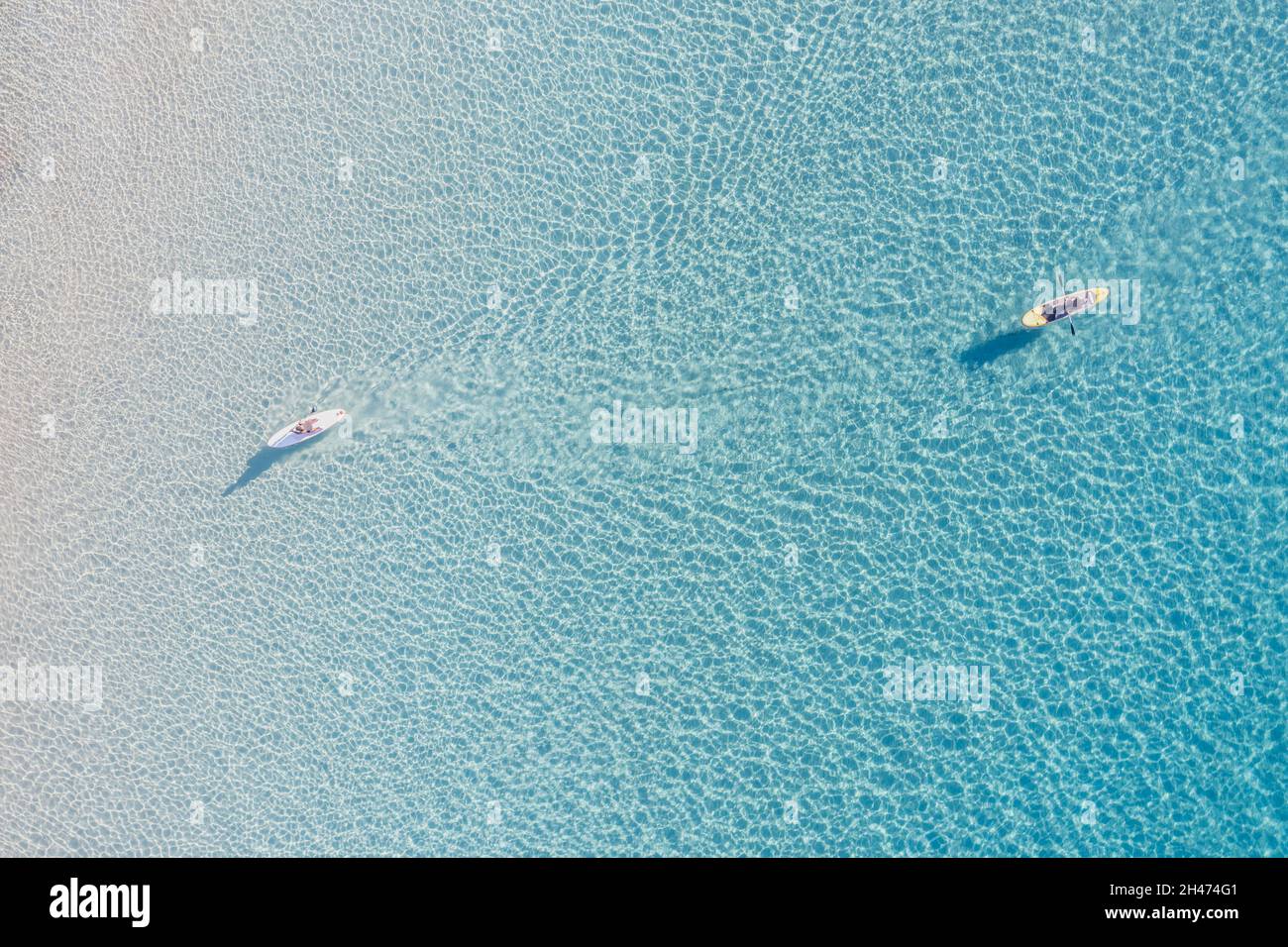 Entspannung in unendlichem klaren blauen ruhigen transparenten Ägäis. Zwei Kanukajaks mit Ruderdrohnen aus der Vogelperspektive. Sommerferien Spaß und gesunder Sport Stockfoto