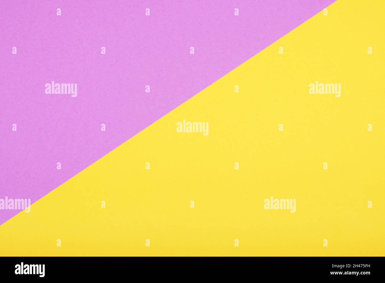 Zweifarbiger Papierhintergrund in Gelb und Rosa Stockfoto