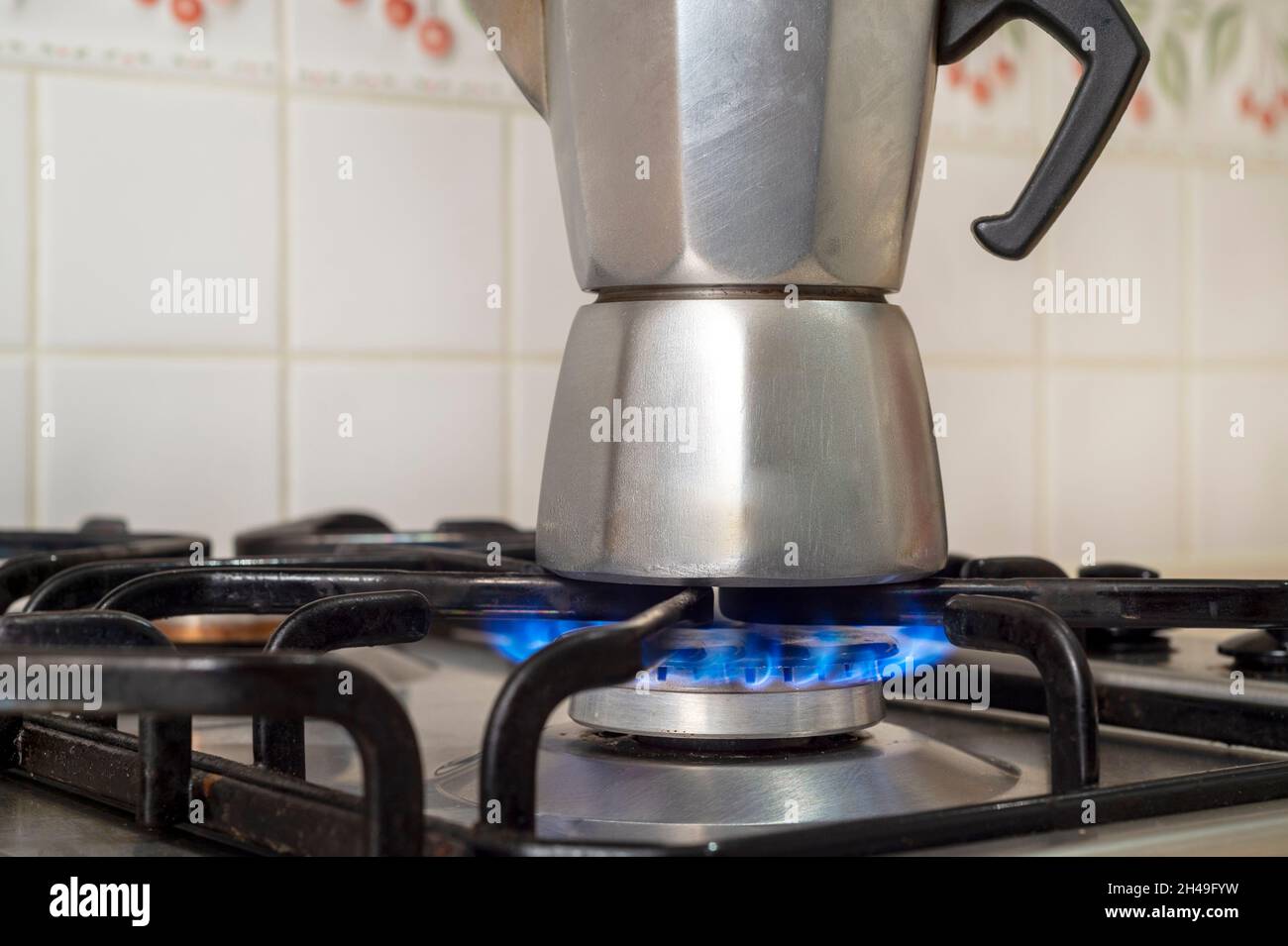 Gasbrennen aus einem Küchengasherd, der eine Kaffeekocher erhitzt Stockfoto