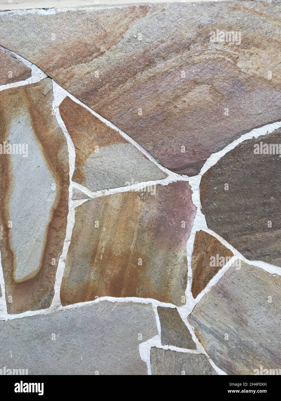 Hintergrund einer Steinbedeckung einer Mauer Stockfoto