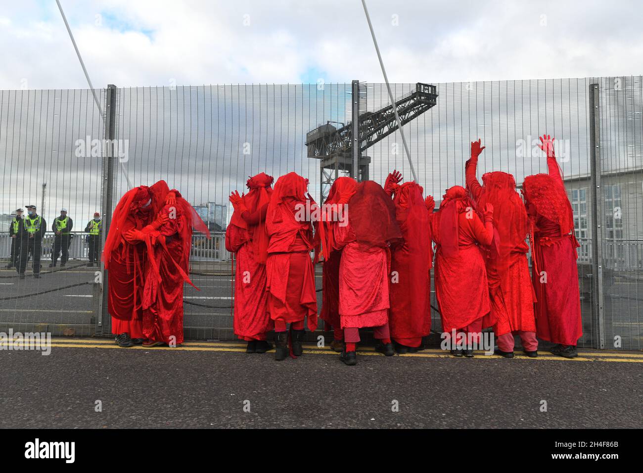 Glasgow, Schottland, Großbritannien, November 02 2021. Extinction Rebellion rot umarmte Demonstranten reisen in einer Prozession durch die Stadt zu den COP 26 Barrikaden, hinter denen sich die Staats- und Regierungschefs der Welt versammeln, um ihre Reaktion auf den Klimawandel zu diskutieren Stockfoto