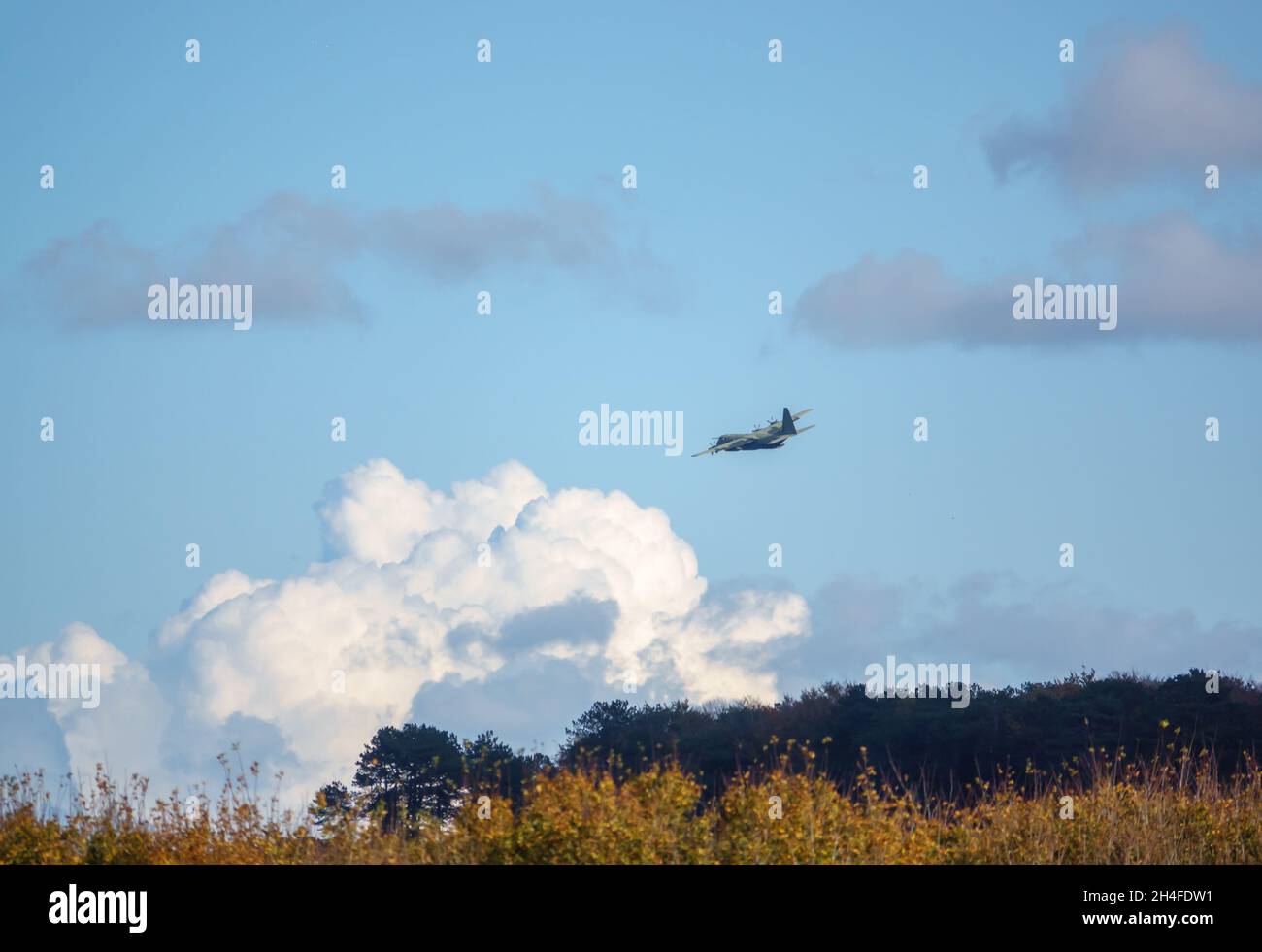 Die britische RAF Lockheed Martin C-130J Hercules-Maschine auf einem Fallschirm für militärische Übungsfracht über dem militärischen Trainingsgebiet der Salisbury Plain, Großbritannien Stockfoto