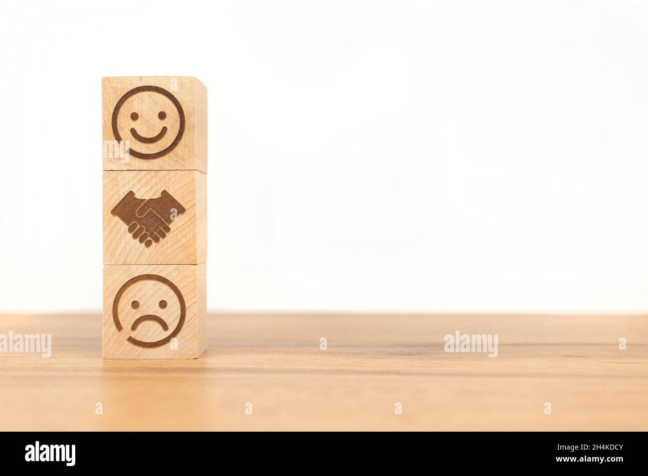 Kundendienst- und Zufriedenheitskonzept. Smiley und trauriges Gesicht-Symbol mit zitternder Hand. Positive Erfahrung Hintergrund, kopieren Raum Foto Stockfoto