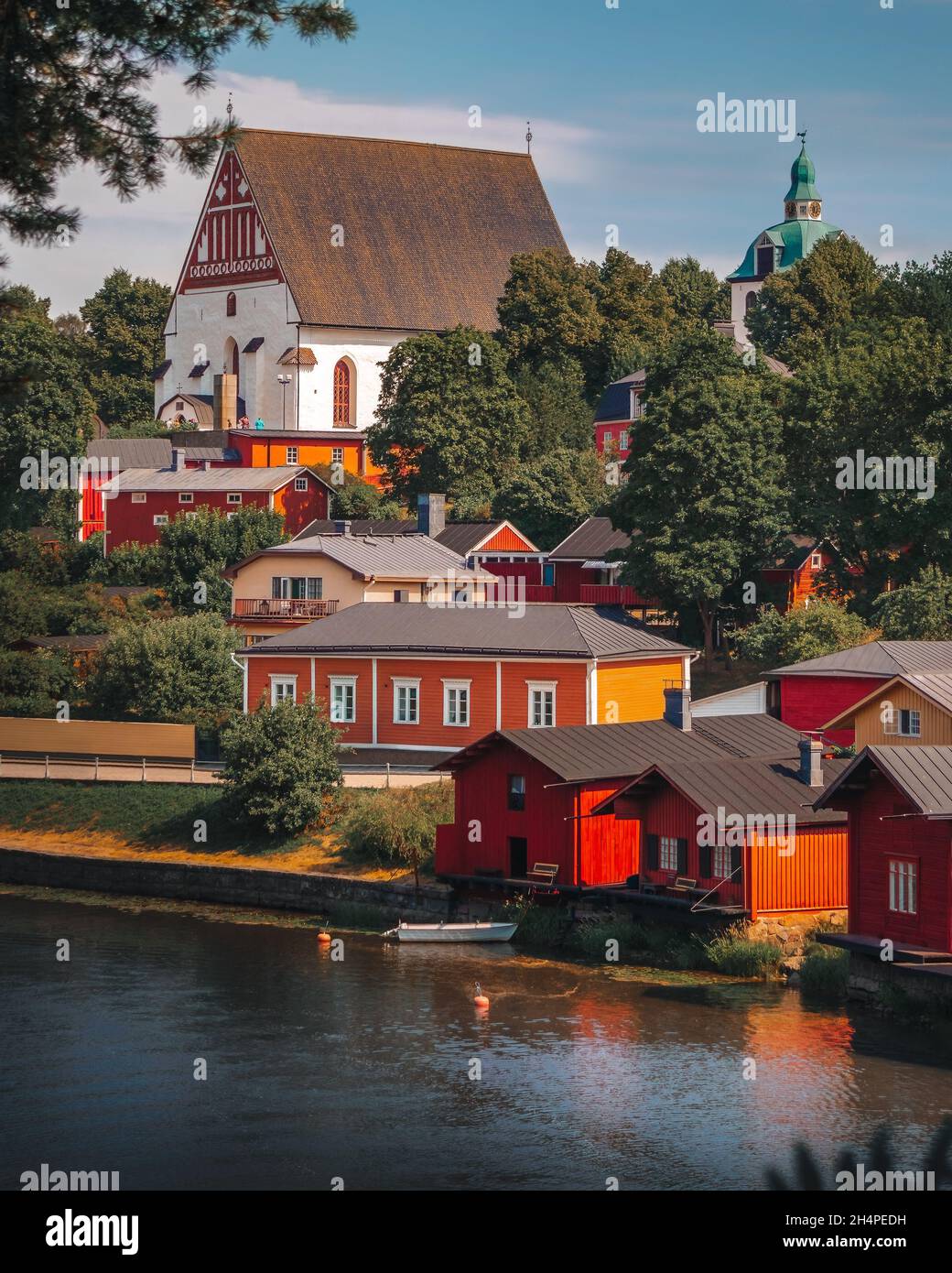 Altstadt von Porvoo in Finnland. Bunte Holzhäuser an einem Hang in der Nähe des Flusses. Steinkirche auf einem Hügel. Finnische Architektur. Skandinavien. Riverside. Stockfoto