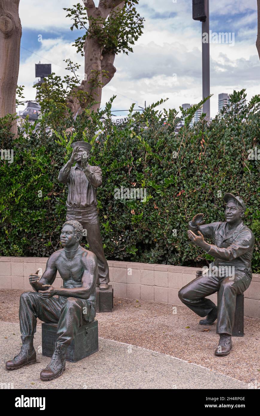San Diego, Kalifornien, USA - 4. Oktober 2021: Ein nationaler Gruß an Bob Hope und die Militärstatuengruppe 3 Männer, alle applaudierenden. Grünes Laub im Rücken Stockfoto
