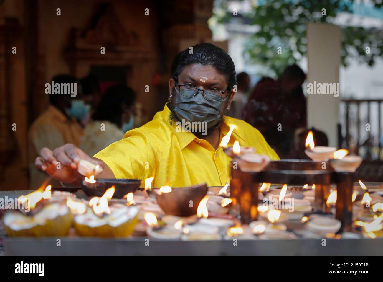 Kuala Lumpur, Malaysia. November 2021. Ein Hindu-Anhänger sah während des Festivals Öllampen anzünden, während er im Tempel der Batu Caves bete.Diwali ist eines der wichtigsten religiösen Feste im Hinduismus. Die Göttin Lakshmi, der gott des Reichtums, wird während Diwali für Glück, Wohlstand und Ruhm verehrt. (Foto von Wong Fok Loy/SOPA Images/Sipa USA) Quelle: SIPA USA/Alamy Live News Stockfoto