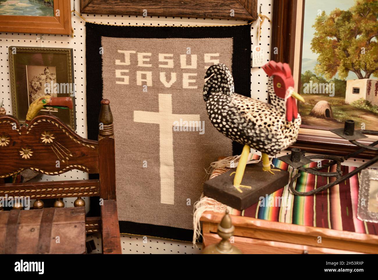 Ein kleiner handgewebter 'Jesus rettet' Teppich zum Verkauf in einem Antiquitätengeschäft in Santa Fe, New Mexico. Stockfoto