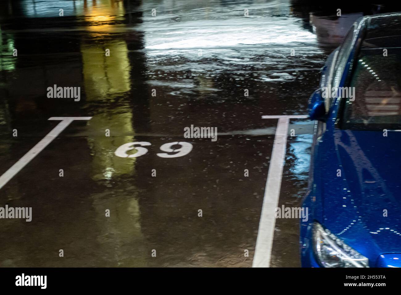 Skizzierte Parkplatz Nummer 69 gewaschen mit Regen, geparktes Auto Stockfoto
