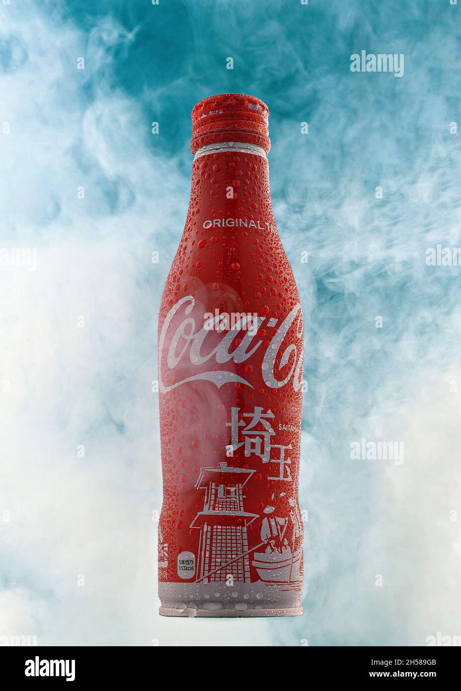 Redaktionelle Aufnahme einer japanischen Flasche von Coca Cola, die auf einer vertikalen, von Nebel umgebenen Flasche mit Wassertropfen auf der Flasche gedreht wurde. Illustrative Einzelflasche Stockfoto