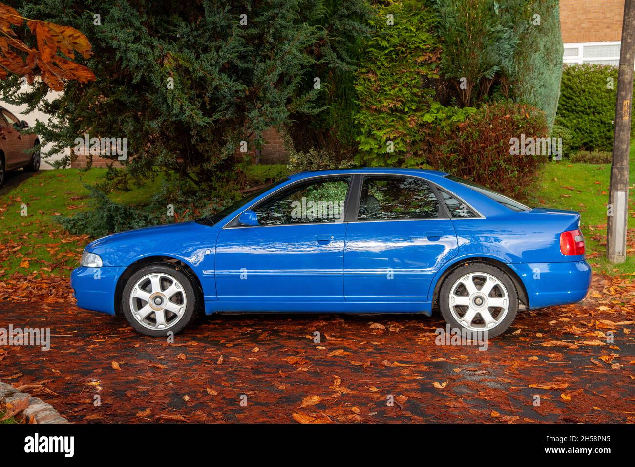 1999 Modelljahr Audi S4 Limousine geparkt auf einer über Blätter gestreuten Vorstadtstraße im frühen Herbst Stockfoto