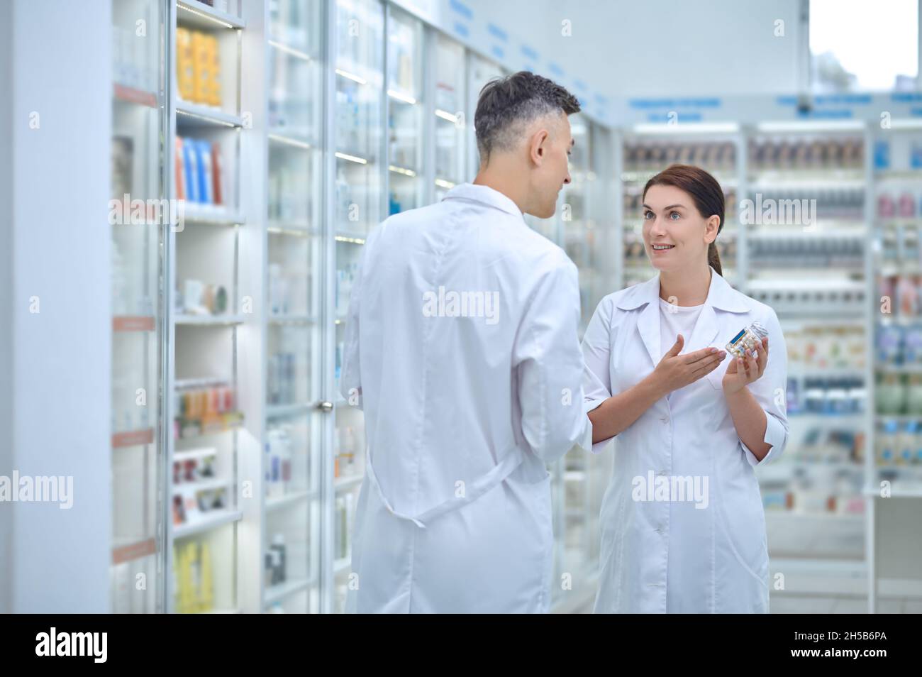 Zwei Apotheker diskutieren Medikamente in der Apotheke Stockfoto