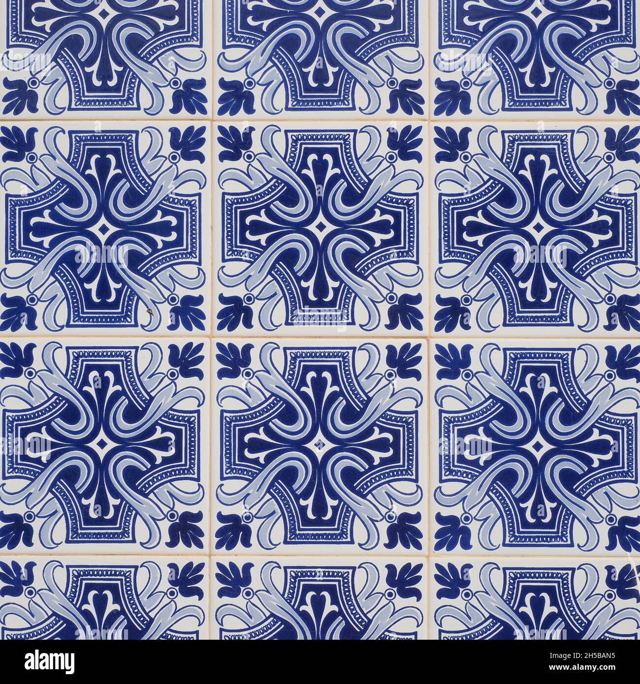 Fragment der Gebäudewand mit bunten keramischen Wandfliesen. Azulejos aus nächster Nähe. Abstrakt dekorativer Hintergrund. Traditionelle, reich verzierte portugiesische Kunst Stockfoto