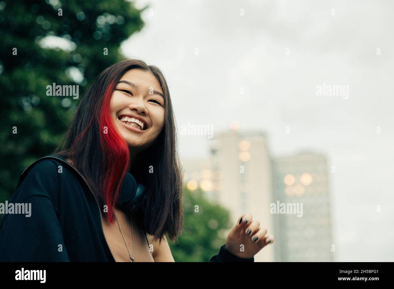 Glückliches Teenager-Mädchen mit rot hervorgehobenen Haaren Stockfoto