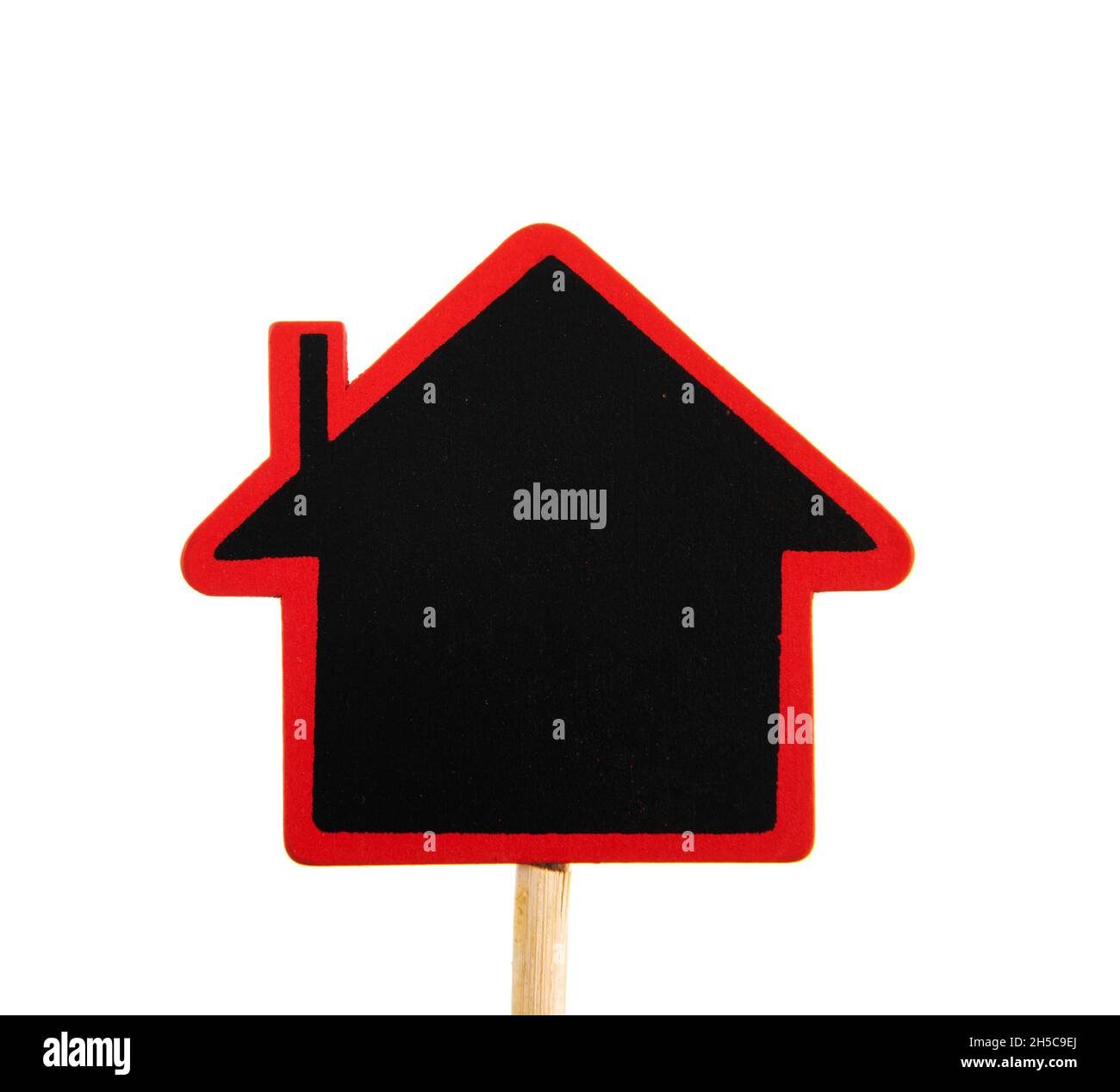 Kleines Haus schwarzes Brett auf Stick isoliert auf weißem Hintergrund Stockfoto