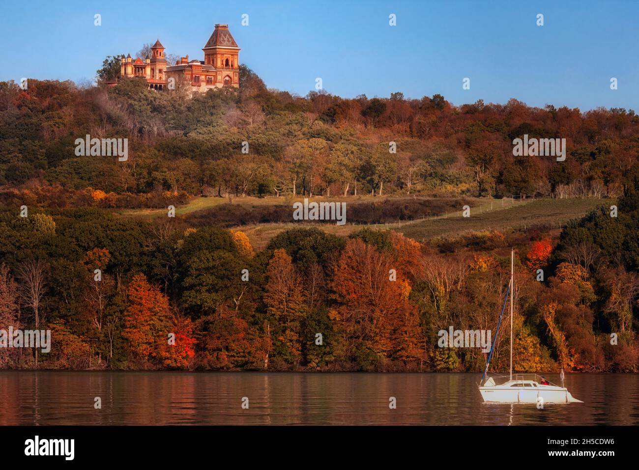 Segeln am Olana Mansion - Blick auf die Olana State Historic Site mit einem Boot, das entlang des Hudson River in der Catstkill Region des Staates Ne segelt Stockfoto